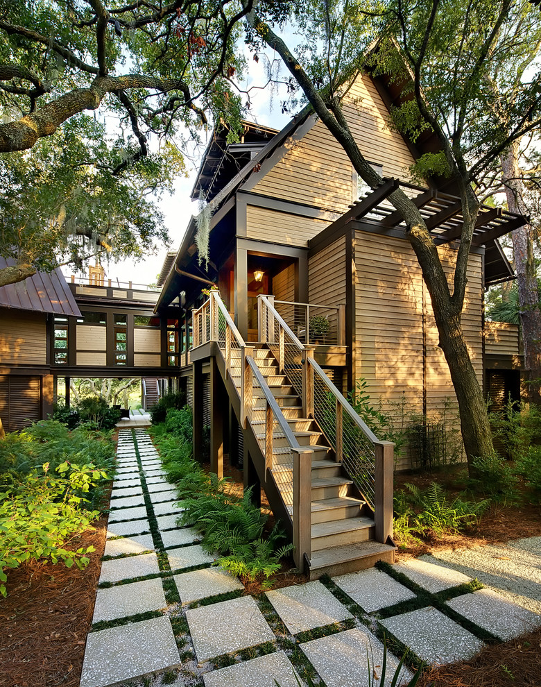 This is an example of a contemporary two floor house exterior in Charleston with wood cladding.