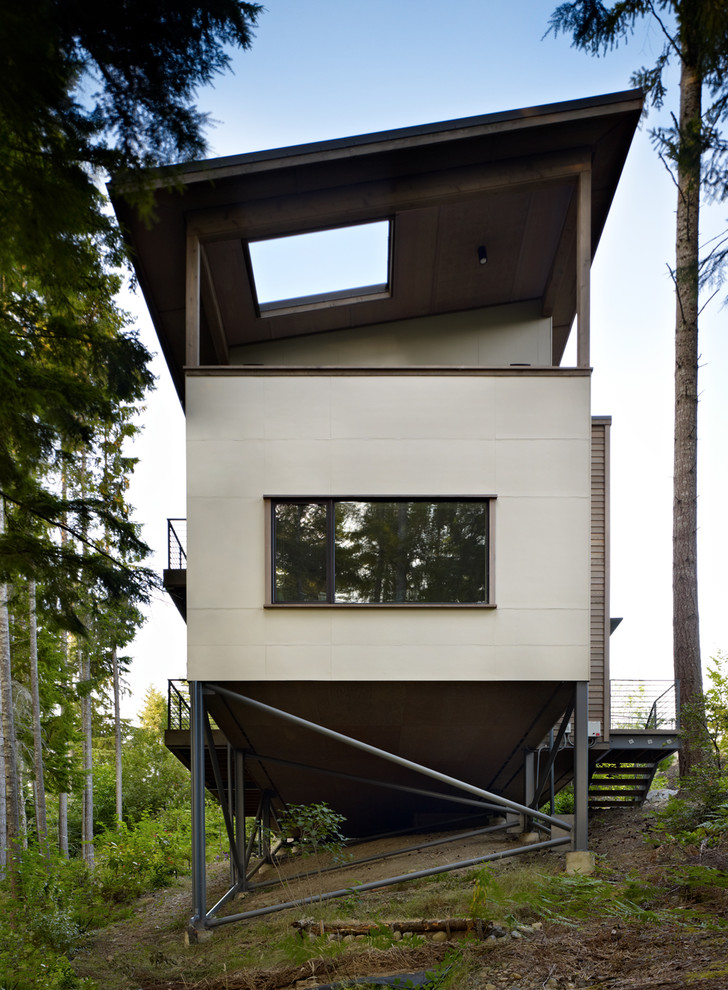 Inspiration for a white contemporary house exterior in Seattle with a lean-to roof.