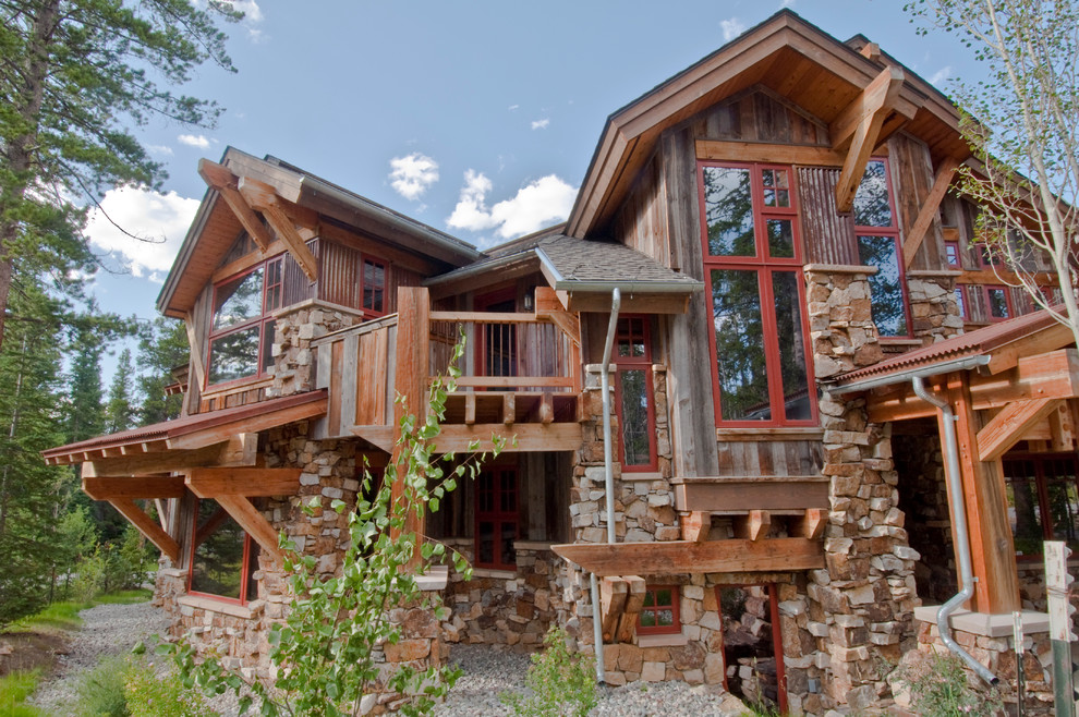 Inspiration for a rustic house exterior in Salt Lake City with stone cladding.