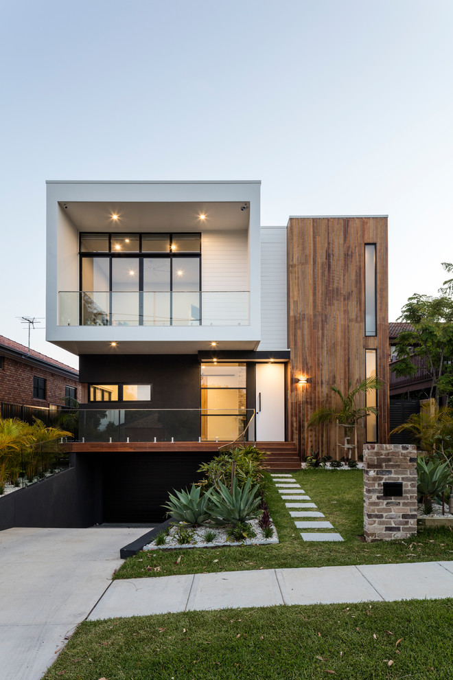 Идея дизайна: двухэтажный, белый частный загородный дом в современном стиле с комбинированной облицовкой и плоской крышей