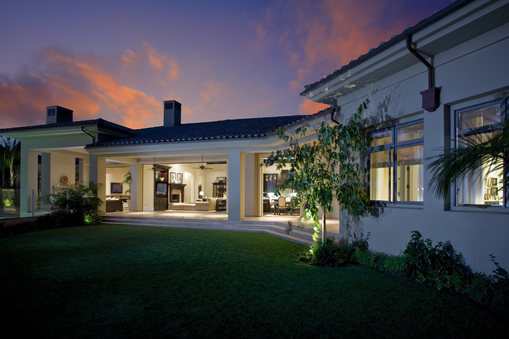 Inspiration for a large and beige classic bungalow render house exterior in Orange County.