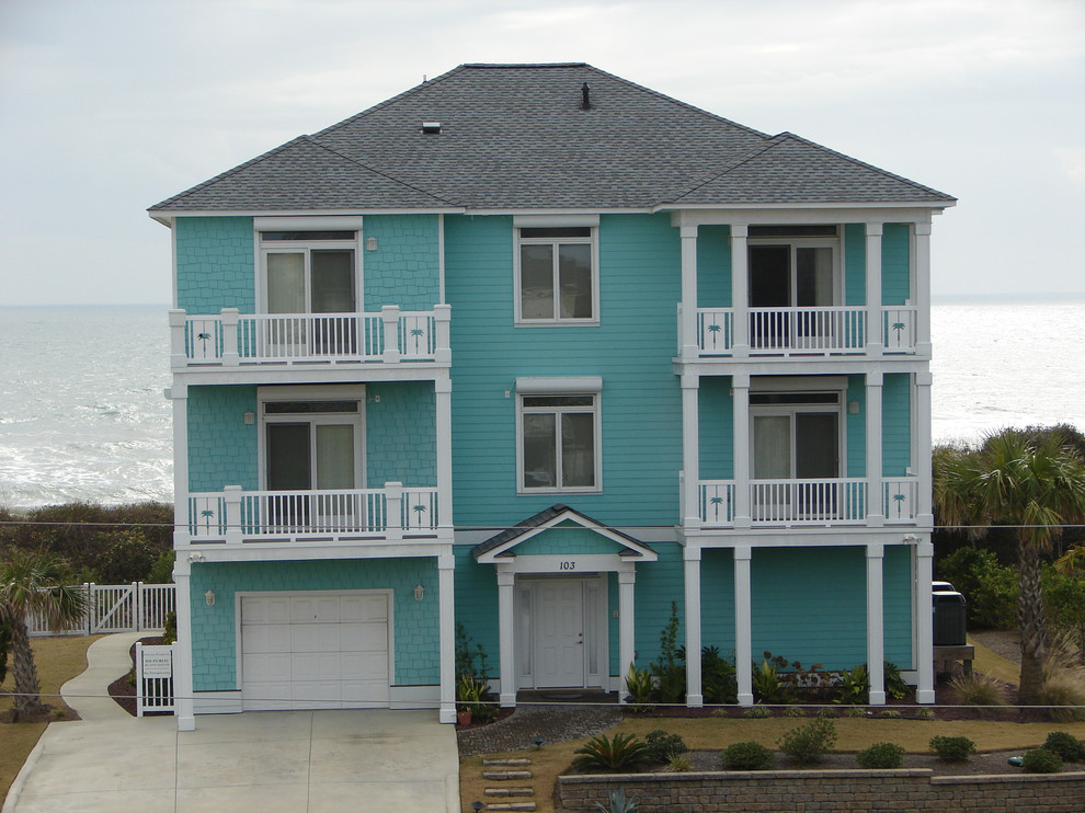 Inspiration for a large tropical blue three-story wood exterior home remodel in Other