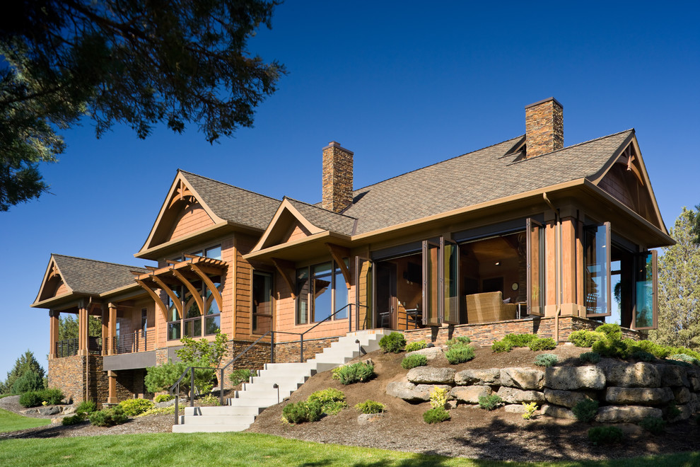 This is an example of a rustic house exterior in Portland with wood cladding.