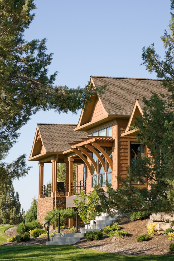 Inspiration for a rustic house exterior in Portland with wood cladding.