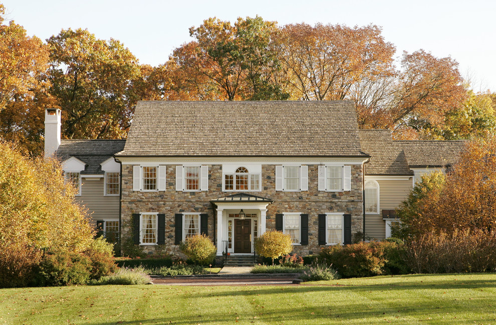 Inspiration for a timeless two-story stone gable roof remodel in Philadelphia