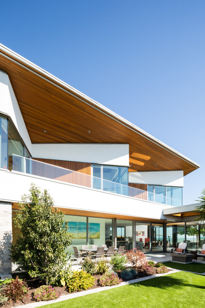 This is an example of a medium sized and gey contemporary two floor house exterior in Vancouver with mixed cladding.