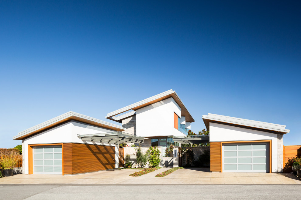 Mid-sized trendy white two-story mixed siding exterior home photo in Vancouver with a shed roof