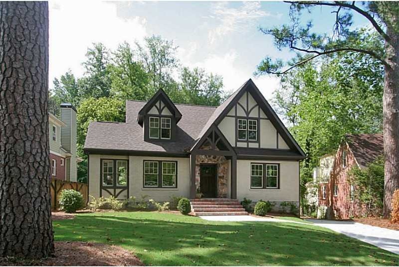 Inspiration for an expansive and beige classic two floor brick detached house in Atlanta with a hip roof and a shingle roof.