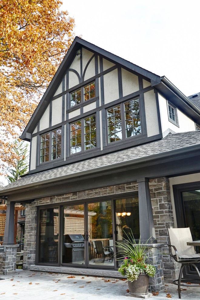 This is an example of a large traditional two floor house exterior in Toronto with stone cladding.