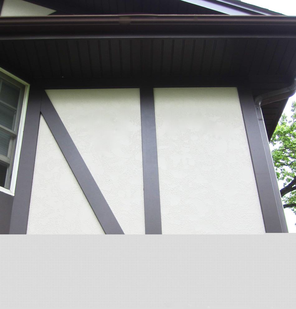 Inredning av ett minimalistiskt mellanstort beige hus, med två våningar, fiberplattor i betong, sadeltak och tak i shingel