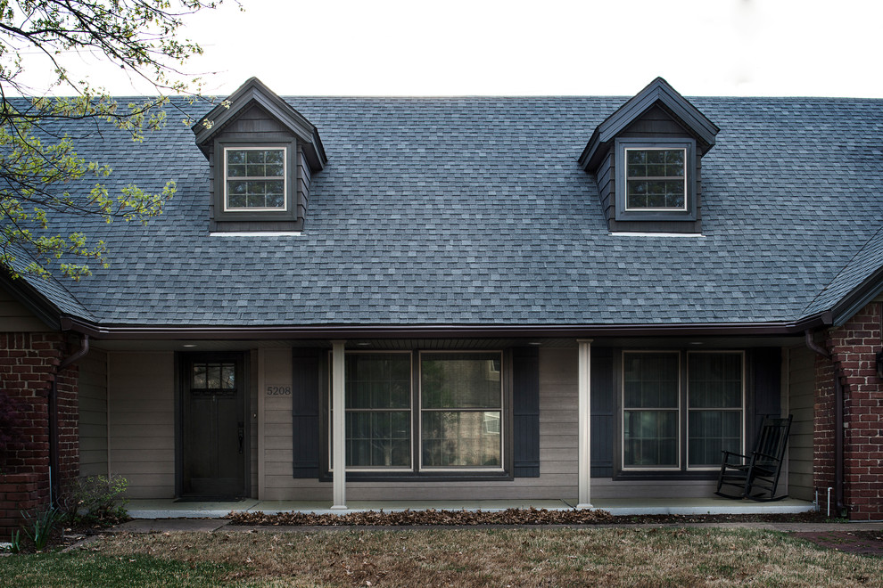 Design ideas for a traditional two floor house exterior in Other with vinyl cladding.