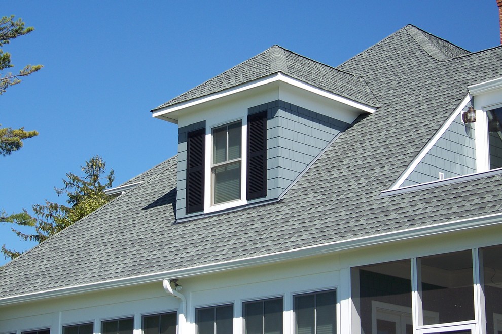 This is an example of a large and blue traditional two floor detached house in Baltimore with wood cladding, a pitched roof and a shingle roof.