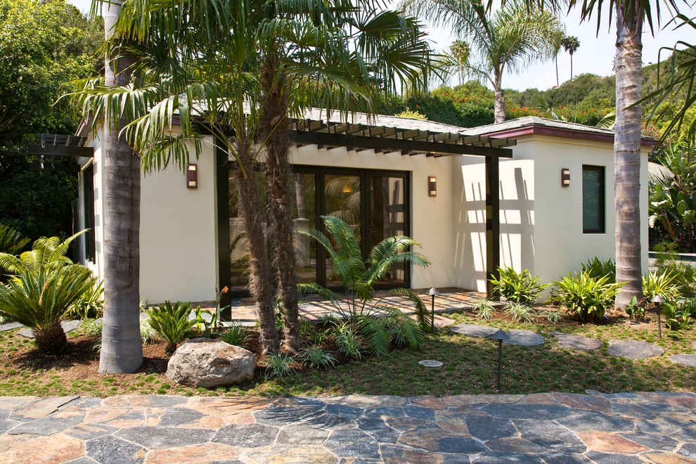 Inspiration for a large and white world-inspired two floor render detached house in Santa Barbara with a hip roof and a shingle roof.