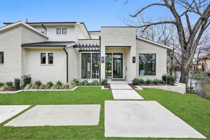 Photo of a large and white classic two floor detached house in Dallas with stone cladding, a lean-to roof and a metal roof.
