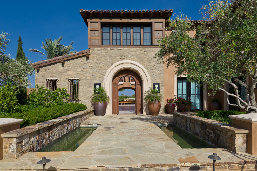 Photo of a mediterranean house exterior in Orange County with stone cladding.