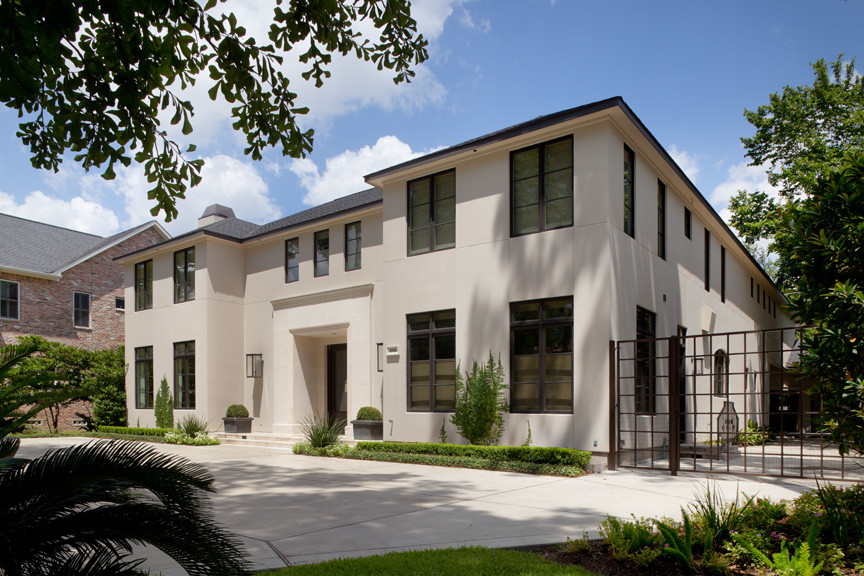 Huge transitional beige two-story stucco exterior home idea in Houston