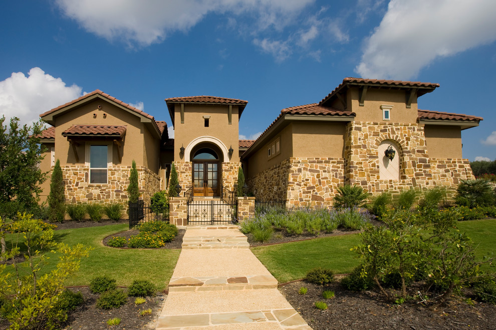 Example of a tuscan exterior home design in Austin