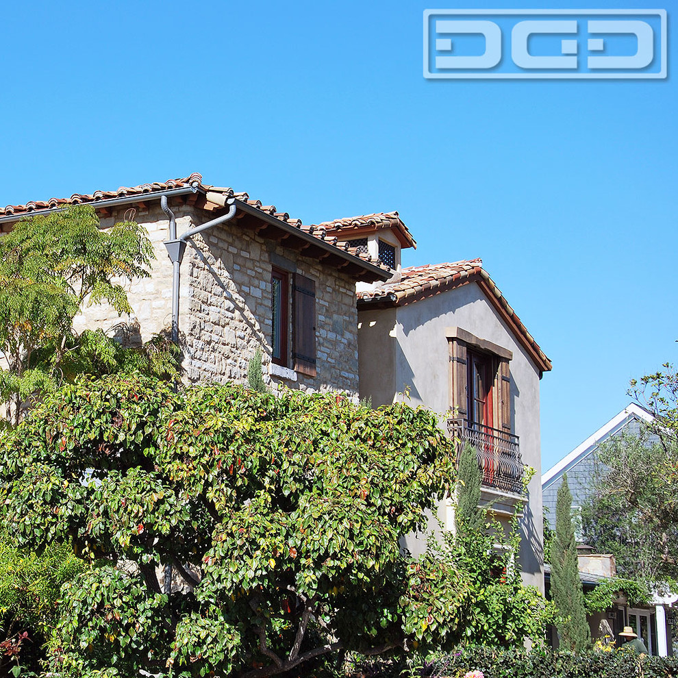 Large and gey rustic two floor house exterior in Orange County with stone cladding.