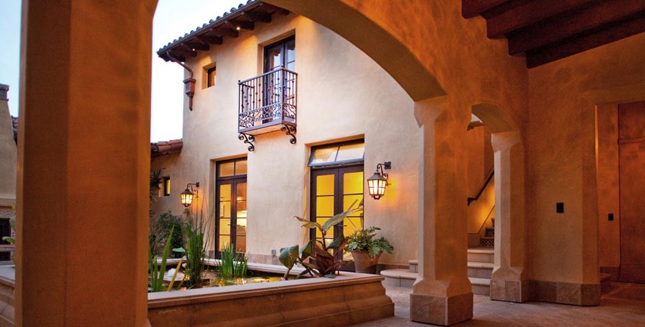 Inspiration for a huge beige one-story stone exterior home remodel in San Diego with a clipped gable roof