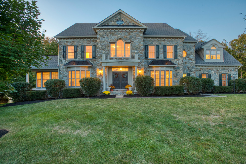 Example of a large classic gray two-story stone exterior home design in DC Metro with a shingle roof and a gray roof