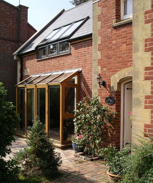 Photo of a rustic brick house exterior in Sussex with a pitched roof.