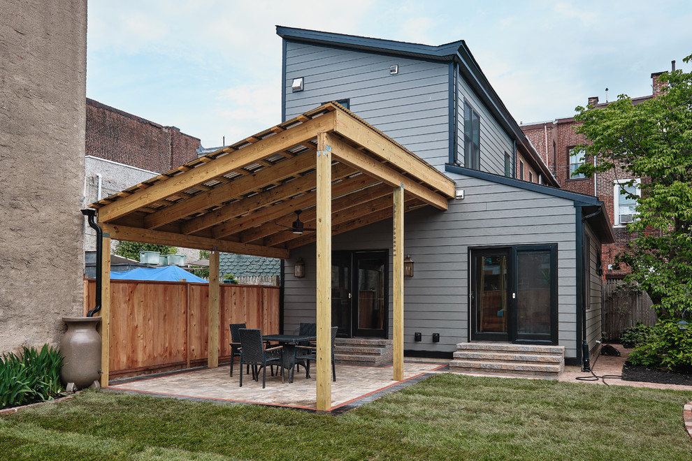 Inspiration for a huge eclectic gray two-story concrete house exterior remodel in Philadelphia with a shed roof and a shingle roof