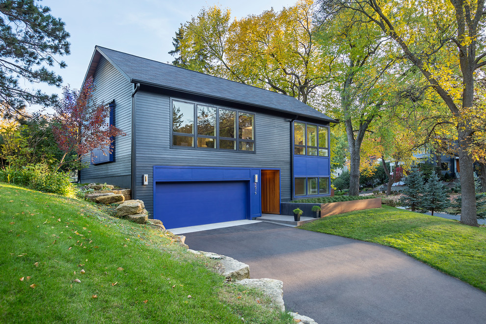 Example of a transitional multicolored two-story exterior home design in Minneapolis with a shingle roof