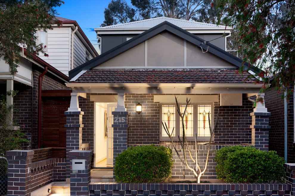 Brown traditional two floor brick detached house in Sydney with a pitched roof.