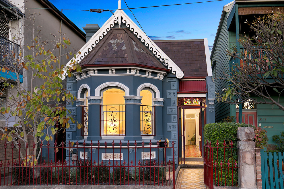Blue victorian bungalow detached house in Sydney with a pitched roof.