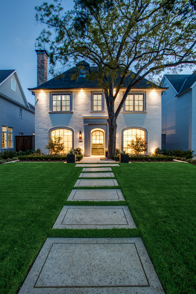 Mid-sized transitional white two-story brick exterior home idea in Dallas with a hip roof