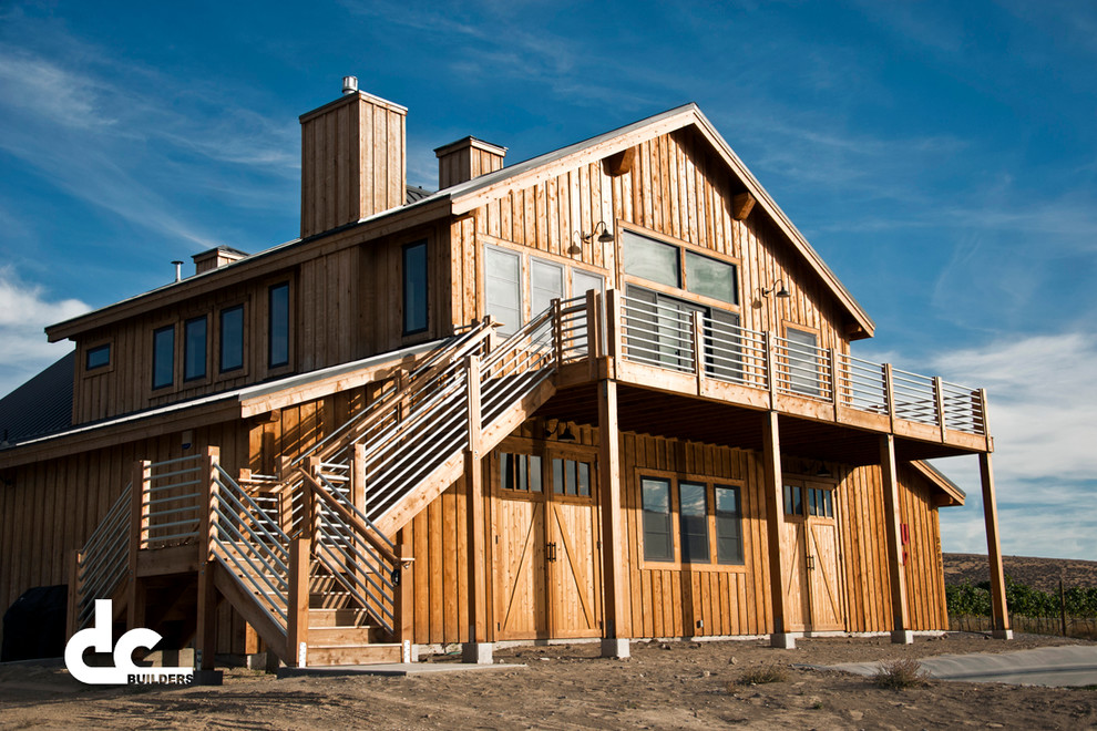 Cette image montre une grande façade de maison marron design en bois à deux étages et plus avec un toit à deux pans.