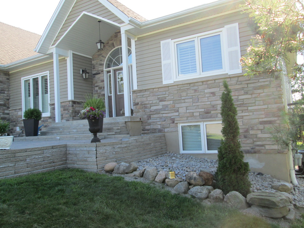 Photo of a medium sized and beige classic bungalow house exterior in Toronto with stone cladding.