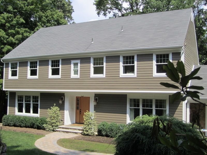 Photo of a medium sized and beige traditional two floor house exterior in New York with vinyl cladding.