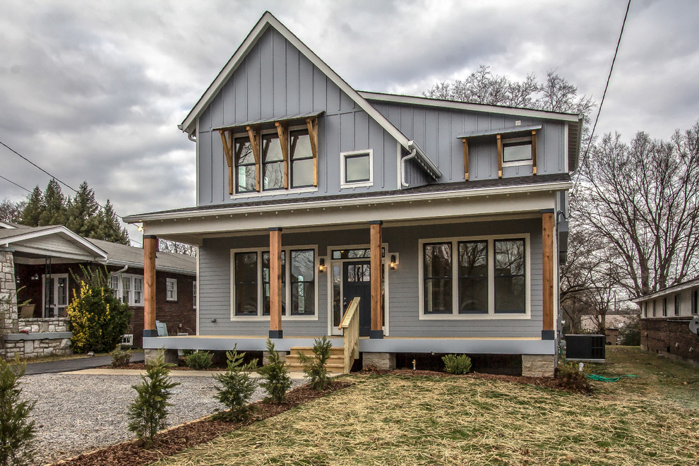 Mid-sized arts and crafts blue two-story vinyl house exterior photo in Nashville with a shingle roof