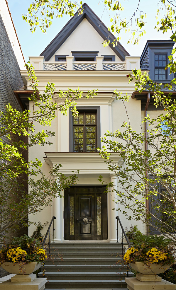Photo of a white traditional house exterior in Chicago with three floors.