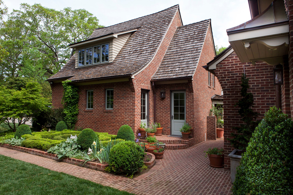 Inspiration for a red contemporary two floor brick house exterior in Charlotte with a pitched roof.