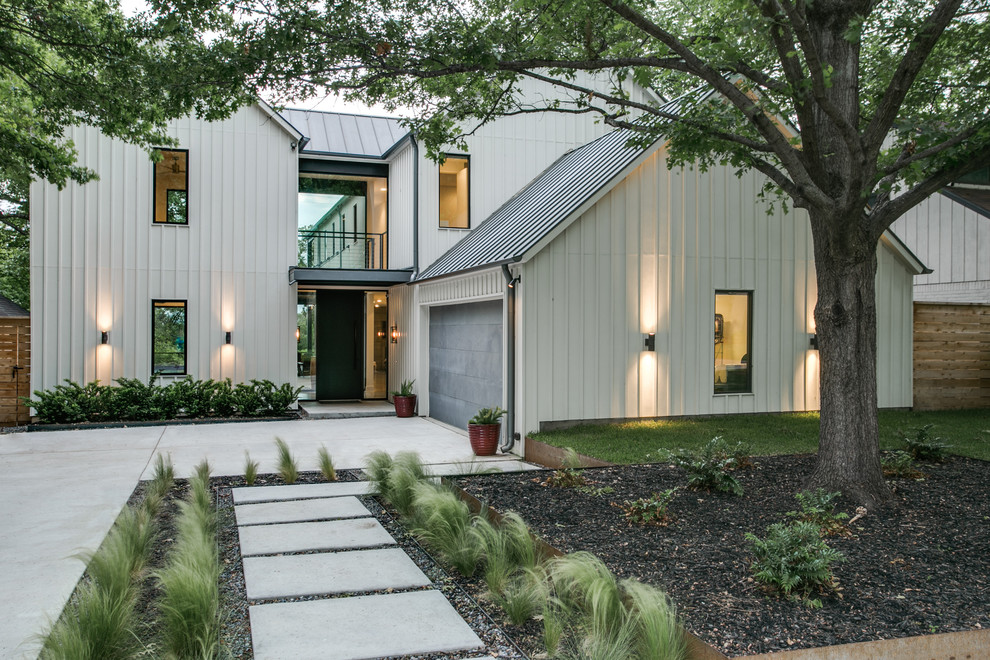 Photo of a large and white traditional two floor house exterior in Dallas with wood cladding and a pitched roof.