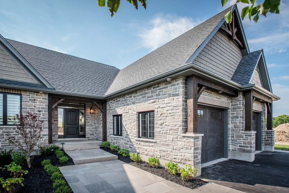 Large craftsman brown one-story stone gable roof idea in Toronto
