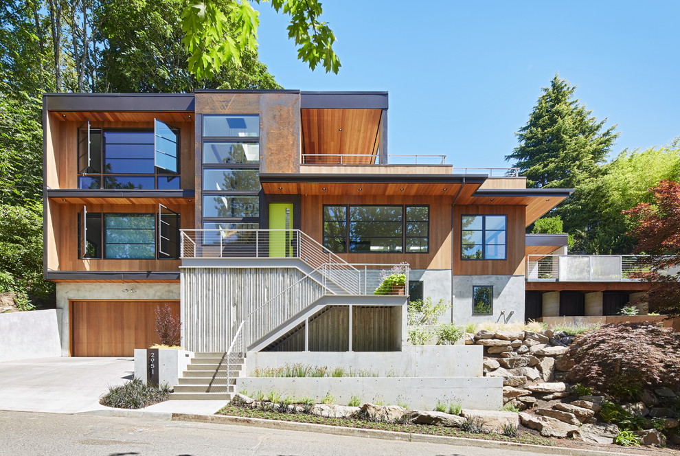 Trendy brown three-story wood exterior home photo in Portland