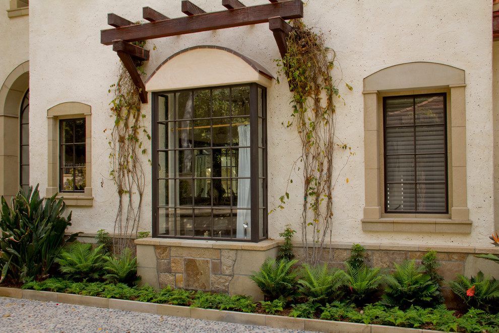 Example of a large tuscan mixed siding exterior home design in Santa Barbara