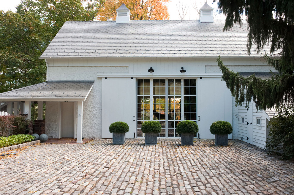Cottage white exterior home idea in Other