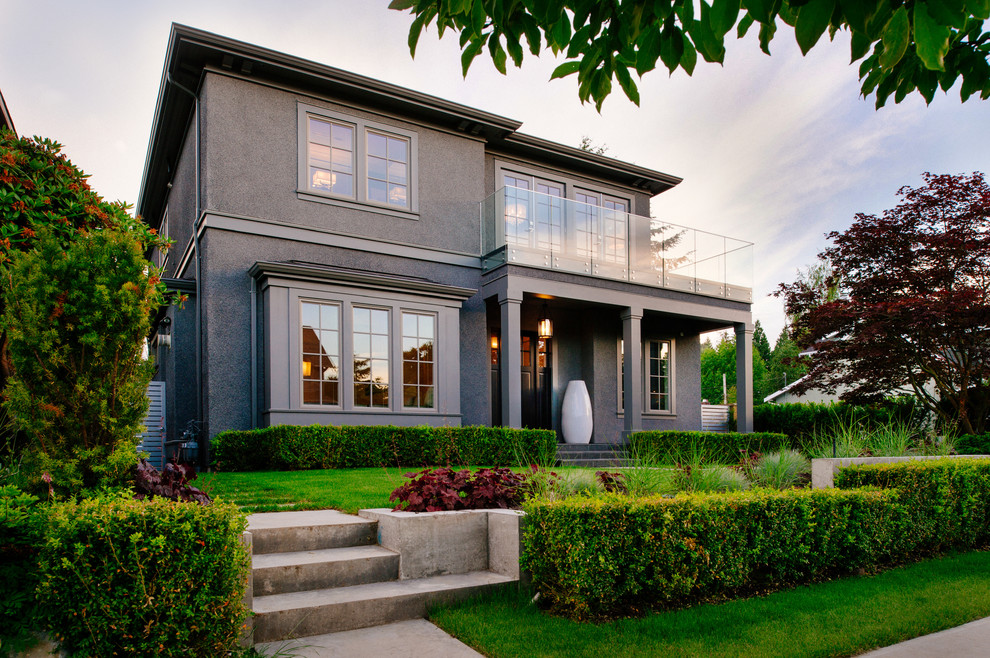 Photo of a large contemporary render house exterior in Vancouver with three floors.