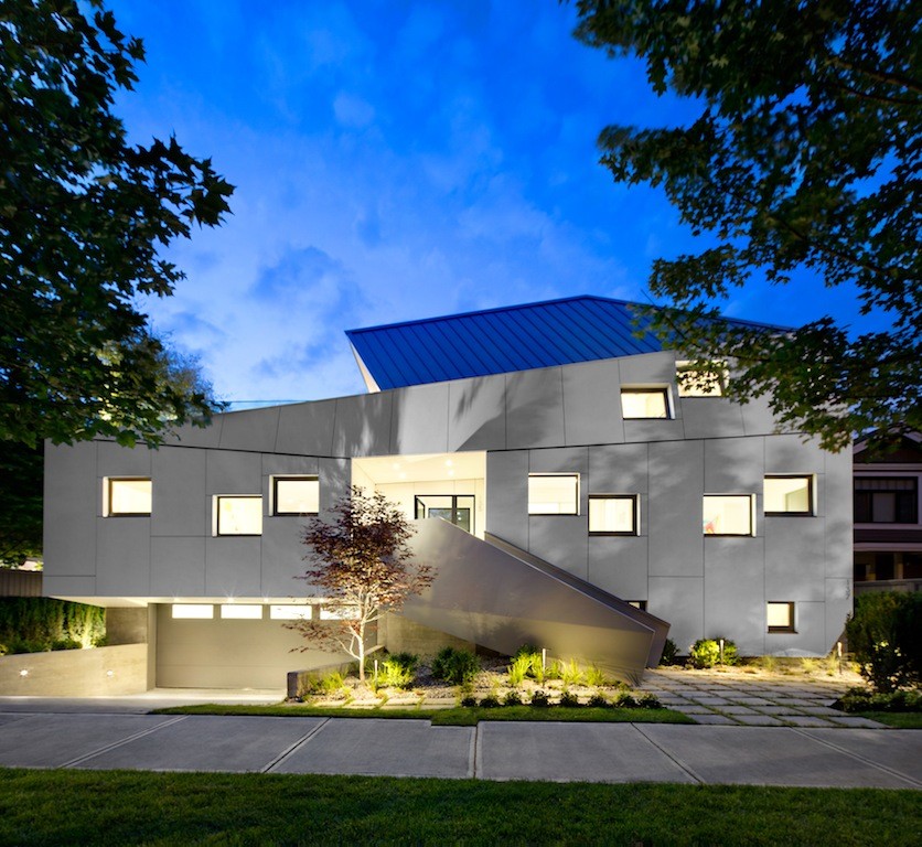 White contemporary house exterior in Vancouver with three floors and concrete fibreboard cladding.