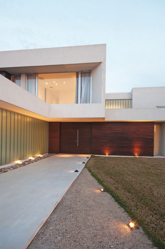 Photo of a contemporary house exterior in Other with wood cladding.