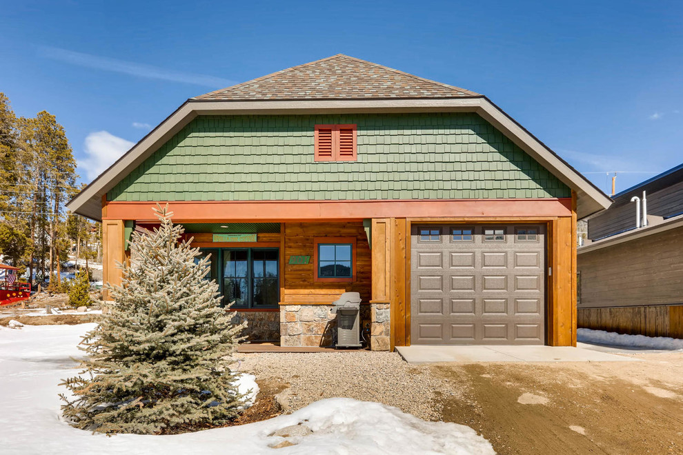 Photo of a medium sized and green traditional two floor detached house in Denver with wood cladding.