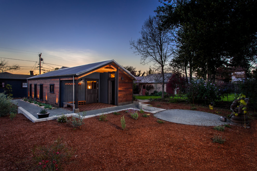 This is an example of a medium sized and brown farmhouse bungalow house exterior in San Francisco with wood cladding.