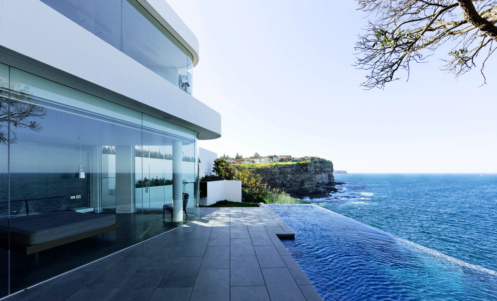Inspiration for a contemporary white two-story stucco flat roof remodel in Sydney