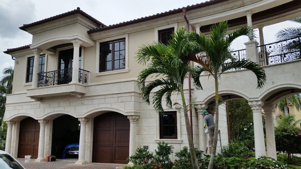 Inspiration for a huge mediterranean three-story stone exterior home remodel in Miami