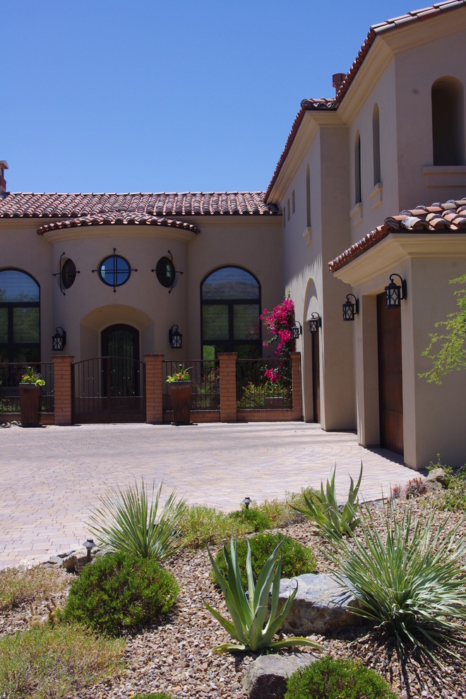 Large southwest beige two-story stucco exterior home photo in Phoenix