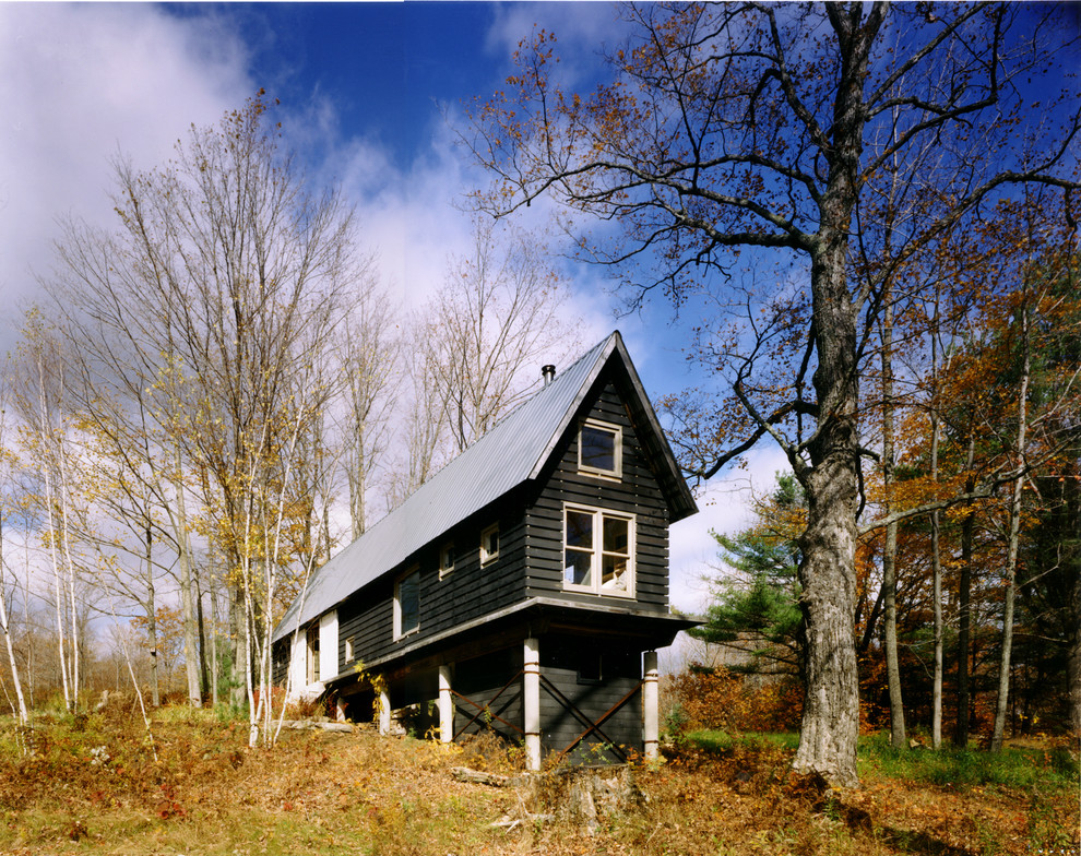 This is an example of a small and black rustic bungalow house exterior in New York.